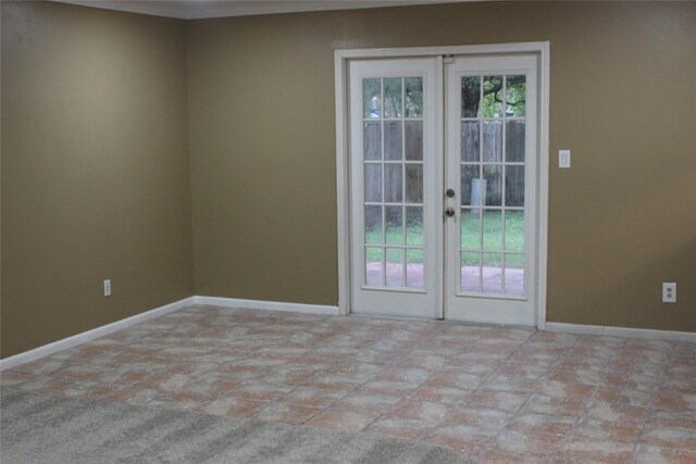 interior space featuring baseboards and french doors