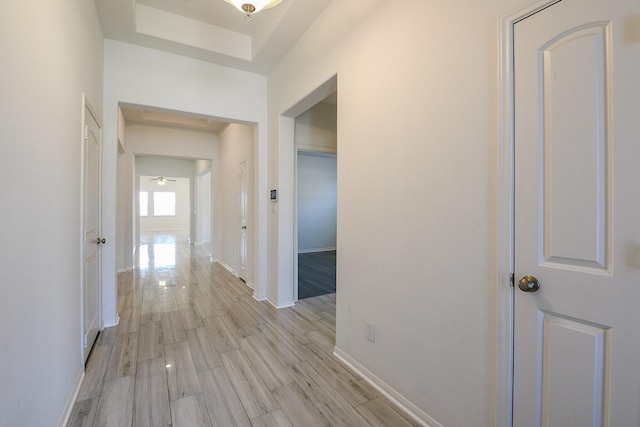 7634 Wrightwood Dr, Pasadena, TX 77505 - hallway with light wood-style floors, baseboards, and a raised ceiling
