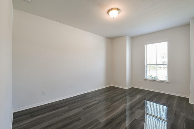 7634 Wrightwood Dr, Pasadena, TX 77505 - unfurnished room with baseboards and dark wood-type flooring
