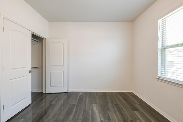 7634 Wrightwood Dr, Pasadena, TX 77505 - unfurnished bedroom featuring baseboards, dark wood-type flooring, and multiple windows