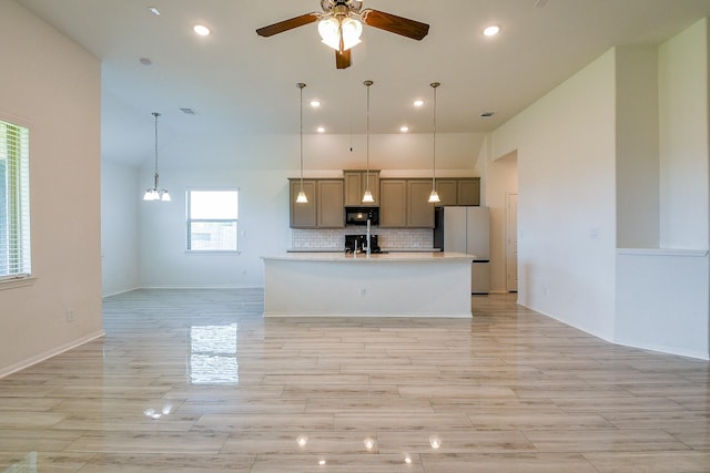 7634 Wrightwood Dr, Pasadena, TX 77505 - kitchen with freestanding refrigerator, black microwave, open floor plan, and a sink