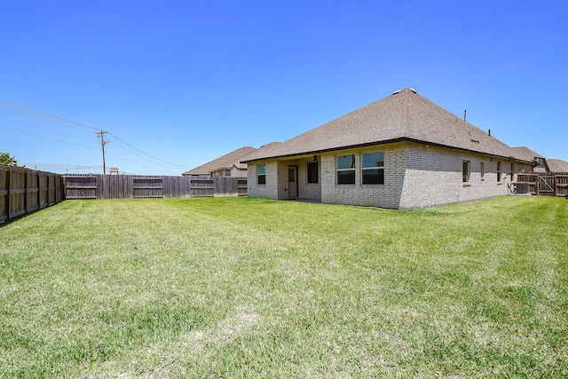 7634 Wrightwood Dr, Pasadena, TX 77505 - back of house featuring a fenced backyard, brick siding, and a lawn