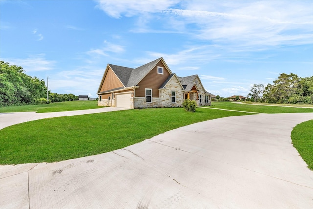 215 Carey Dr, Brenham, TX 77833 - view of front of home with concrete driveway, a garage, stone siding, and a front yard