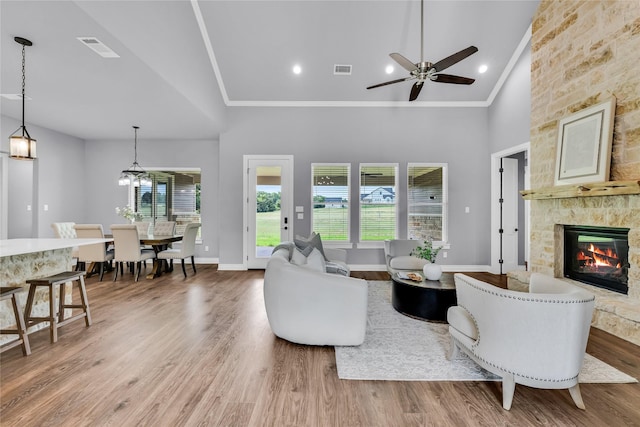215 Carey Dr, Brenham, TX 77833 - living area with a ceiling fan, a healthy amount of sunlight, a fireplace, and visible vents