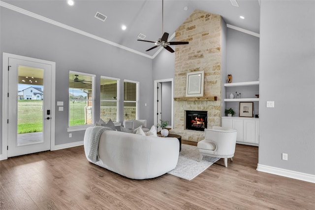 215 Carey Dr, Brenham, TX 77833 - living room featuring baseboards, a stone fireplace, and wood finished floors