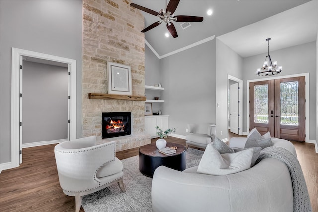215 Carey Dr, Brenham, TX 77833 - living room with french doors, wood finished floors, baseboards, and ceiling fan with notable chandelier
