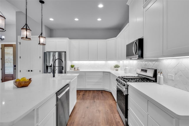 215 Carey Dr, Brenham, TX 77833 - kitchen with light countertops, stainless steel appliances, and tasteful backsplash