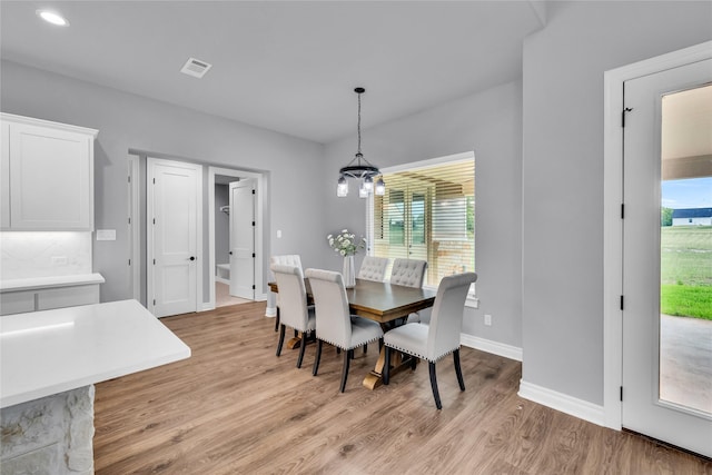 215 Carey Dr, Brenham, TX 77833 - dining area featuring light wood-style flooring, a notable chandelier, visible vents, baseboards, and recessed lighting