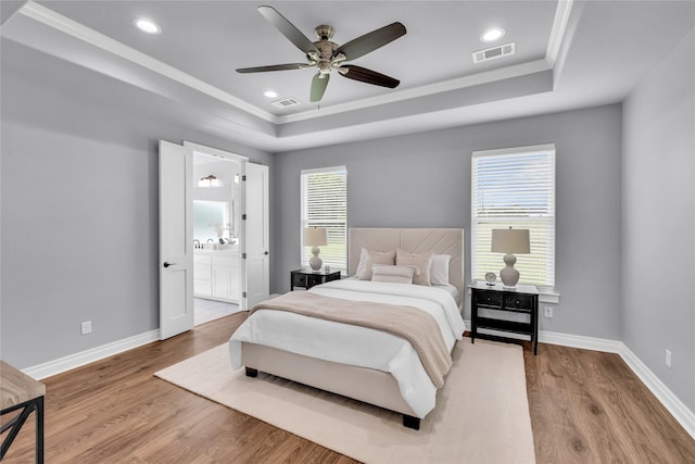 215 Carey Dr, Brenham, TX 77833 - bedroom with visible vents, a raised ceiling, and ornamental molding