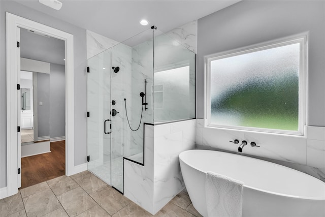 215 Carey Dr, Brenham, TX 77833 - bathroom with a soaking tub and a marble finish shower