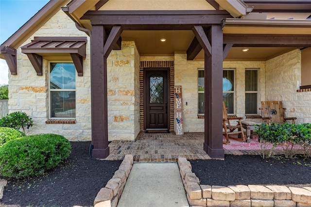 1806 Bridge Gate Ln, Katy, TX 77494 - doorway to property featuring stone siding and a porch