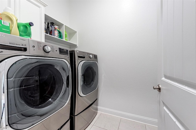 1806 Bridge Gate Ln, Katy, TX 77494 - laundry area featuring baseboards, laundry area, light tile patterned flooring, and washer and clothes dryer