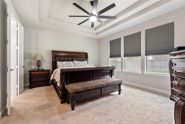 1806 Bridge Gate Ln, Katy, TX 77494 - carpeted bedroom featuring a tray ceiling, baseboards, and a ceiling fan