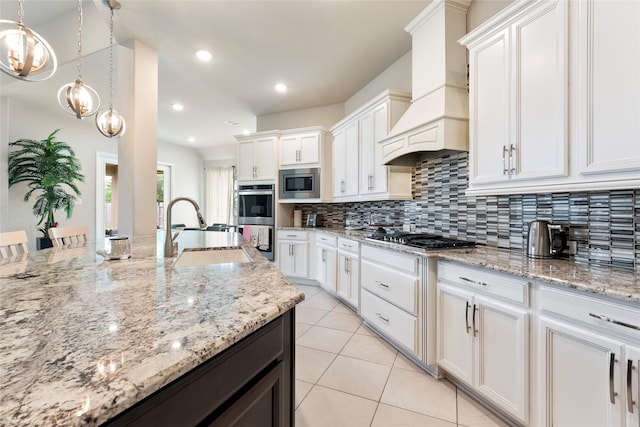1806 Bridge Gate Ln, Katy, TX 77494 - kitchen with a sink, stainless steel appliances, white cabinets, decorative backsplash, and premium range hood