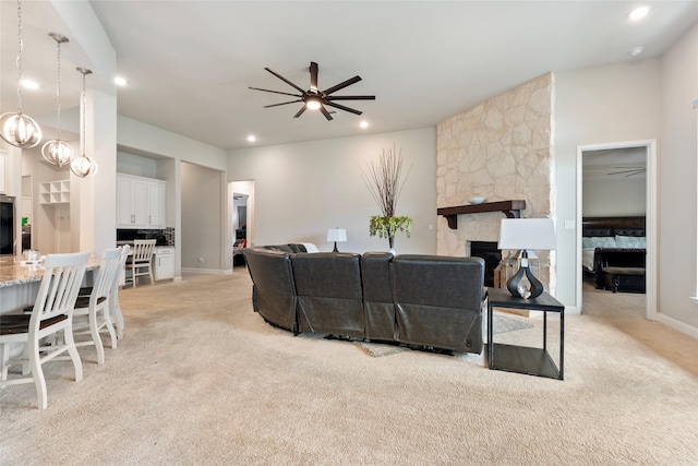 1806 Bridge Gate Ln, Katy, TX 77494 - living room featuring ceiling fan, light carpet, a stone fireplace, and recessed lighting