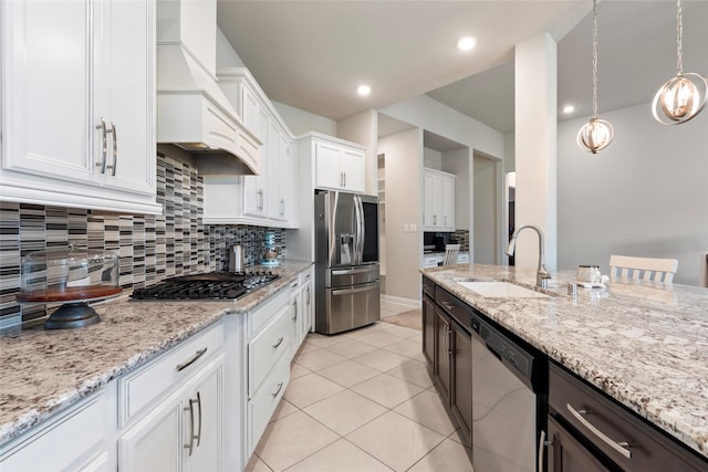 1806 Bridge Gate Ln, Katy, TX 77494 - kitchen featuring a sink, stainless steel appliances, white cabinets, tasteful backsplash, and custom exhaust hood