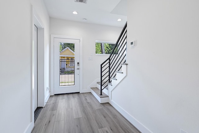 3313 Baer St, Houston, TX 77020 - doorway to outside featuring baseboards, stairs, recessed lighting, and light wood-style floors