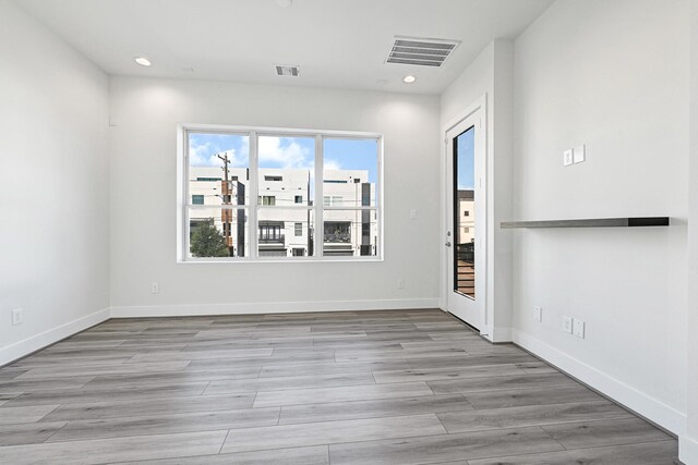 3313 Baer St, Houston, TX 77020 - unfurnished room with wood finished floors, recessed lighting, and baseboards