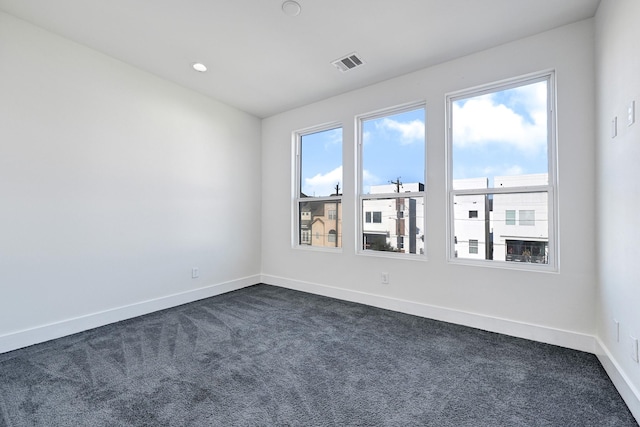 3313 Baer St, Houston, TX 77020 - spare room featuring dark colored carpet, baseboards, and recessed lighting