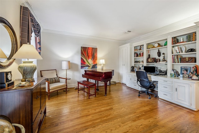2002 Anvil Dr, Houston, TX 77090 - office area featuring light wood-style floors, built in study area, and crown molding
