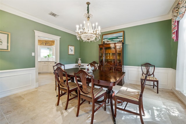 2002 Anvil Dr, Houston, TX 77090 - dining space featuring a chandelier, ornamental molding, a decorative wall, and wainscoting