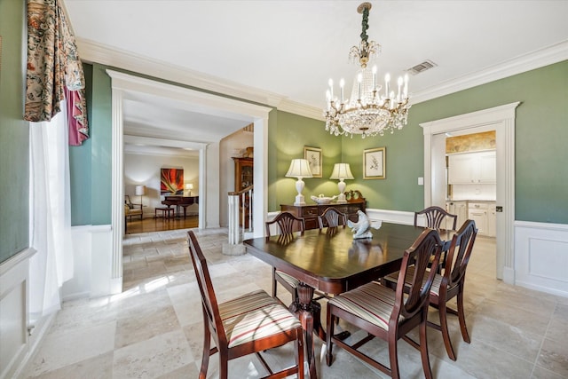 2002 Anvil Dr, Houston, TX 77090 - dining area with a chandelier, a decorative wall, crown molding, and a wainscoted wall