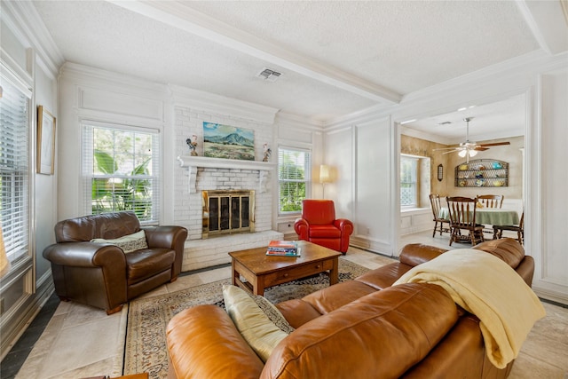 2002 Anvil Dr, Houston, TX 77090 - living room featuring crown molding, a brick fireplace, a textured ceiling, beamed ceiling, and ceiling fan