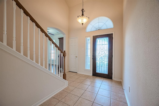 2107 Auburn Vale St, Katy, TX 77493 - foyer with high vaulted ceiling, stairway, arched walkways, light tile patterned floors, and baseboards