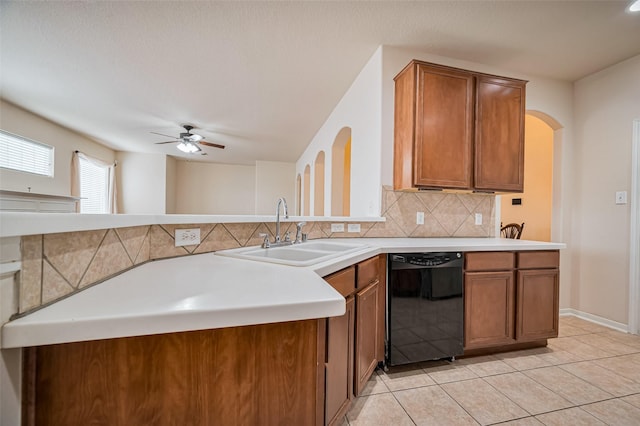2107 Auburn Vale St, Katy, TX 77493 - kitchen featuring a sink, brown cabinetry, black dishwasher, backsplash, and a ceiling fan