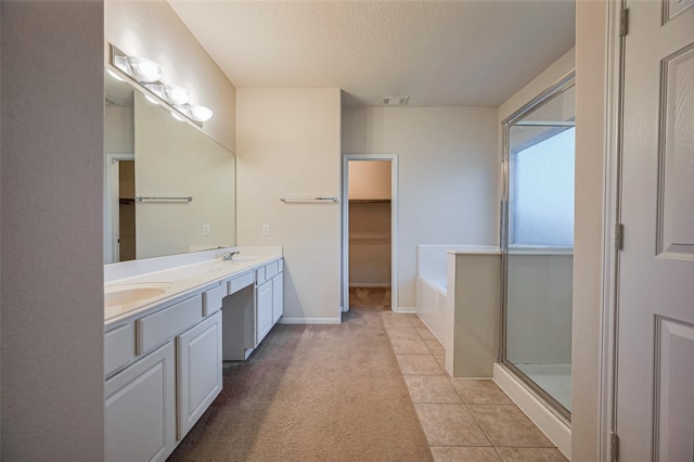 2107 Auburn Vale St, Katy, TX 77493 - full bath featuring a textured ceiling, visible vents, a bath, tile patterned flooring, and double vanity