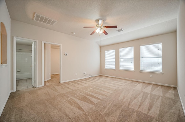 2107 Auburn Vale St, Katy, TX 77493 - unfurnished bedroom featuring light colored carpet, ensuite bathroom, visible vents, and baseboards