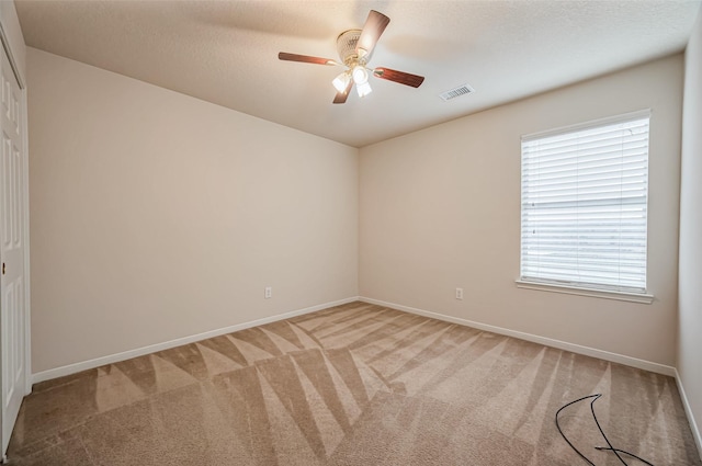 2107 Auburn Vale St, Katy, TX 77493 - empty room featuring light colored carpet, baseboards, a ceiling fan, and visible vents