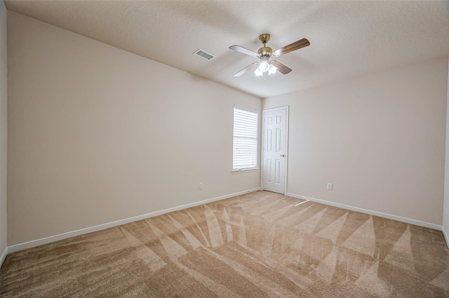2107 Auburn Vale St, Katy, TX 77493 - empty room featuring light colored carpet, a textured ceiling, visible vents, a ceiling fan, and baseboards