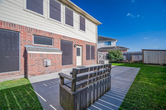 2107 Auburn Vale St, Katy, TX 77493 - back of property featuring a yard, a patio area, fence, and brick siding