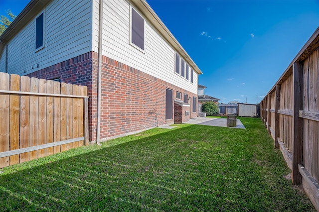 2107 Auburn Vale St, Katy, TX 77493 - view of side of home featuring a lawn, a patio area, brick siding, and a fenced backyard