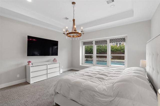 10610 Grace Hollow Dr, Cypress, TX 77433 - carpeted bedroom featuring a tray ceiling, crown molding, visible vents, baseboards, and a chandelier