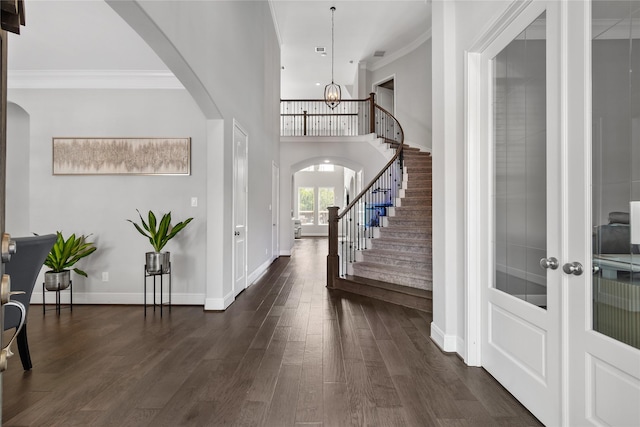 10610 Grace Hollow Dr, Cypress, TX 77433 - entryway featuring stairs, ornamental molding, dark wood finished floors, arched walkways, and a notable chandelier