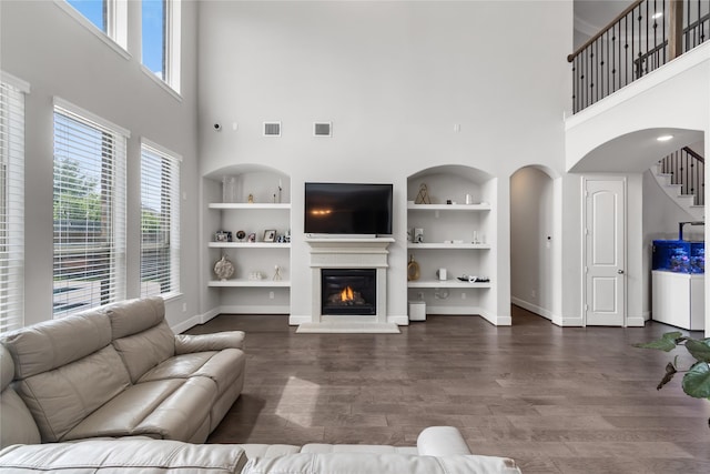 10610 Grace Hollow Dr, Cypress, TX 77433 - living room with built in features, visible vents, and a high ceiling