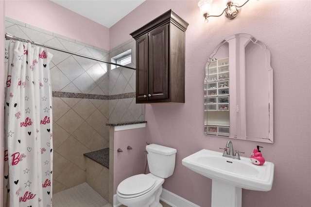 10610 Grace Hollow Dr, Cypress, TX 77433 - full bathroom with toilet, tiled shower, and a sink
