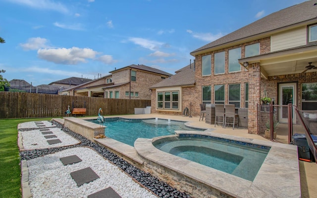 10610 Grace Hollow Dr, Cypress, TX 77433 - view of pool featuring a pool with connected hot tub, outdoor dry bar, ceiling fan, a fenced backyard, and a patio area