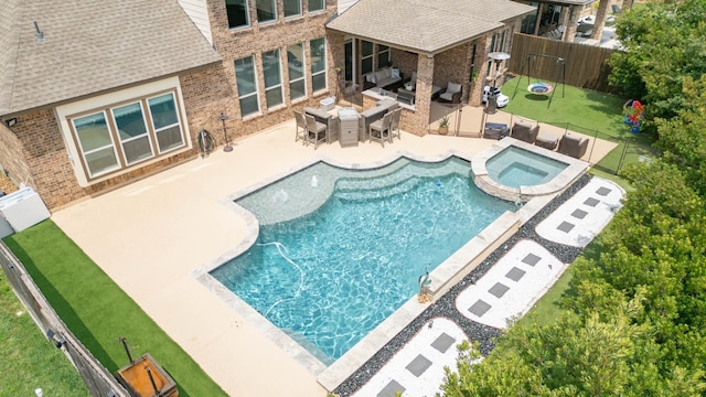 10610 Grace Hollow Dr, Cypress, TX 77433 - view of swimming pool with a patio, outdoor dining space, a pool with connected hot tub, a fenced backyard, and an outdoor living space
