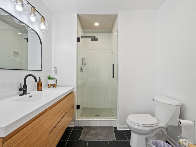 full bathroom featuring toilet, tile patterned floors, vanity, and a shower stall