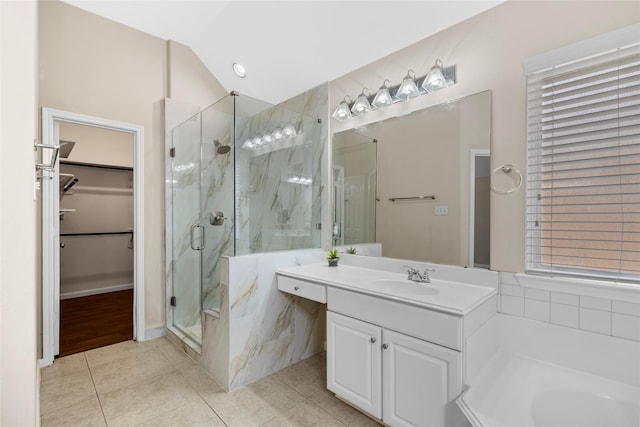 22022 Bridgestone Hawk Ct, Spring, TX 77388 - full bath with vanity, a marble finish shower, tile patterned floors, vaulted ceiling, and a spacious closet