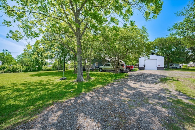 161281/2 Ridlon St, Channelview, TX 77530 - view of front facade with an outdoor structure, a detached garage, a front yard, and driveway