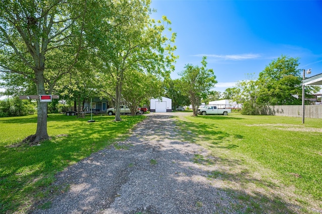 161281/2 Ridlon St, Channelview, TX 77530 - view of property hidden behind natural elements with an outdoor structure and gravel driveway