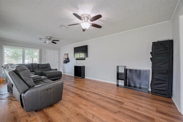 161281/2 Ridlon St, Channelview, TX 77530 - living area featuring a ceiling fan, light wood-type flooring, crown molding, and baseboards