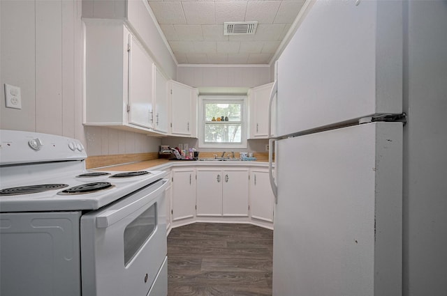 161281/2 Ridlon St, Channelview, TX 77530 - kitchen with white appliances, dark wood finished floors, white cabinetry, light countertops, and ornamental molding