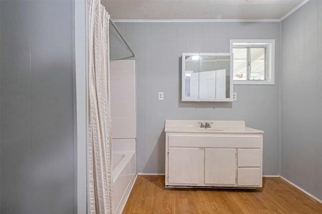 161281/2 Ridlon St, Channelview, TX 77530 - bathroom featuring wood finished floors, shower / tub combo with curtain, vanity, ornamental molding, and baseboards