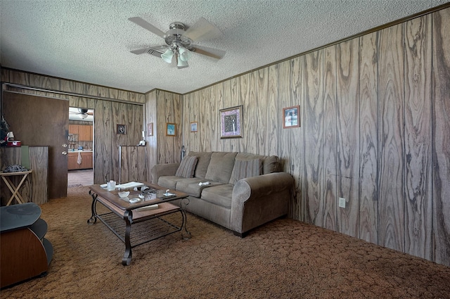 161281/2 Ridlon St, Channelview, TX 77530 - carpeted living room with a textured ceiling, a ceiling fan, and wooden walls