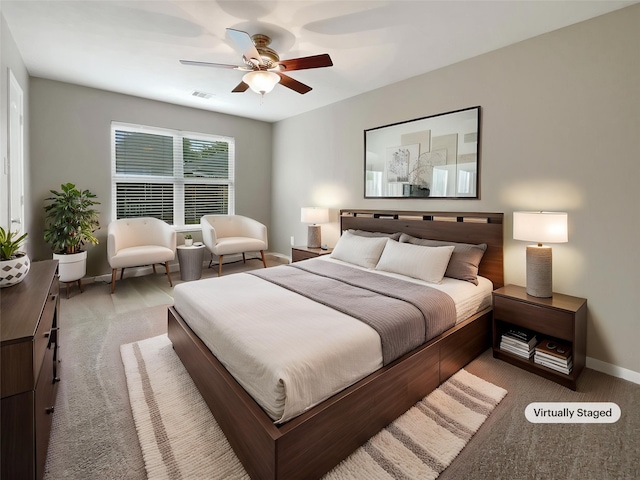 bedroom featuring baseboards, ceiling fan, light carpet, and visible vents